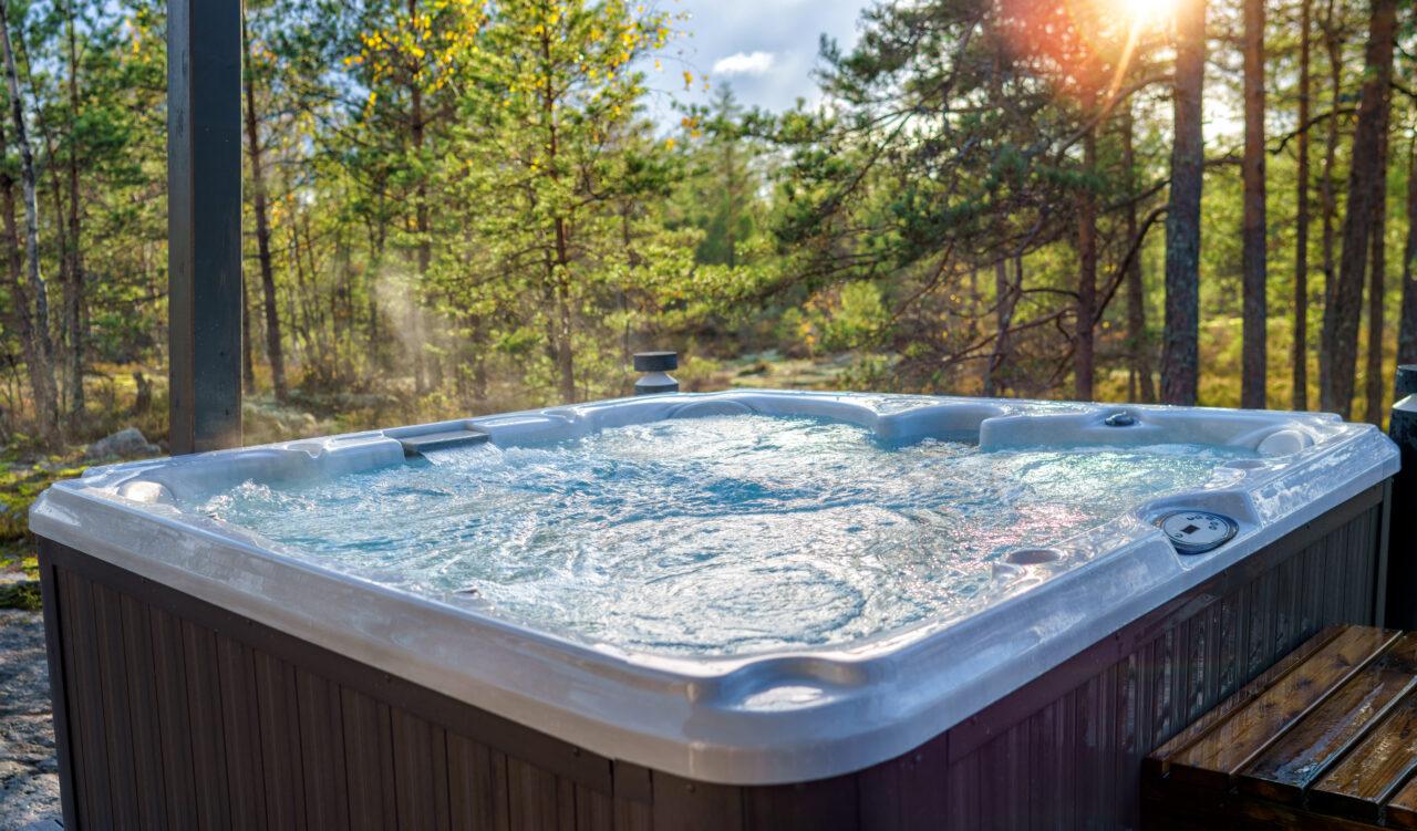 A warm hot tub in a beautiful forest landscape at sunset. You ca