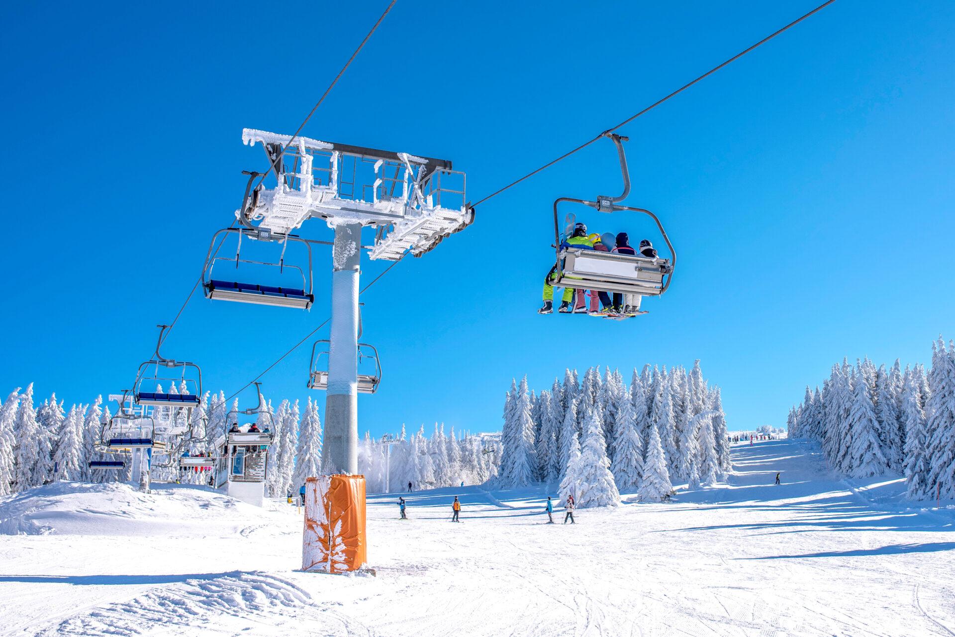 Winter sports concept. Skiers on chairlift at mountain ski resor